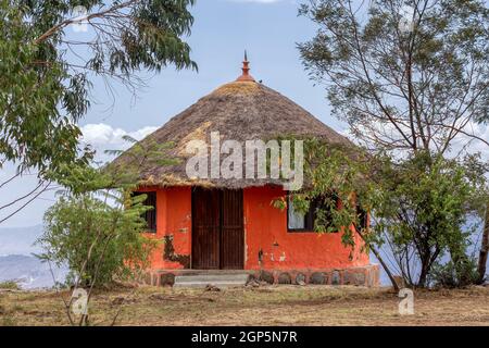 Beautiful colored traditional ethiopian house situated in mountain landscape with scenic view to canyon. Debre Libanos, Ethiopia, Africa. Stock Photo