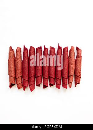 Red fruit leather rolls isolated on white. Fruit candy - pastille. Top view Stock Photo