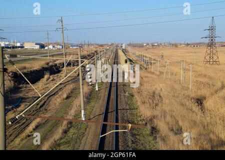 Plot railway. Top view on the rails. High-voltage power lines for electric trains. Stock Photo