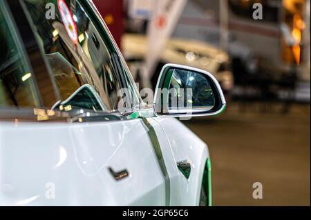 side rear-view mirror on a modern car, selective focus, view from behind, closeup Stock Photo