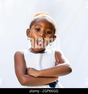 Portrait of cute African girl with surprising face expression.Isolated against light background. Stock Photo