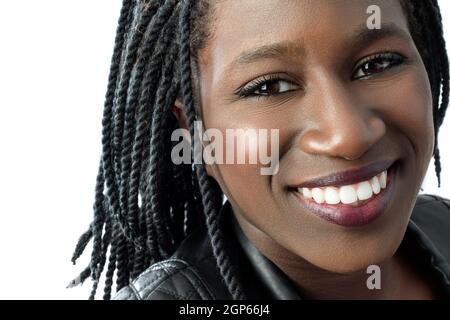 Macro close up face shot of attractive young african woman with charming smile.Isolated on white background. Stock Photo