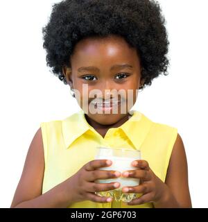 Close up portrait of little black girl holding glass of milk.Kid with afro hairstyle Isolated on white background. Stock Photo