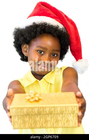 Close up portrait of little african girl wearing red christmas hat holding golden box.Isolated on white background. Stock Photo