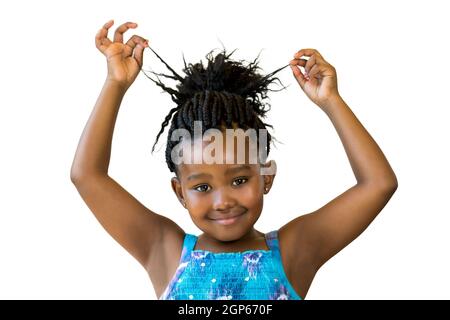 Close up portrait little african girl playing with braided hair.Isolated against white background. Stock Photo