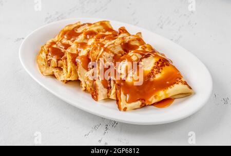 Stack of homemade crepes topped with caramel Stock Photo - Alamy