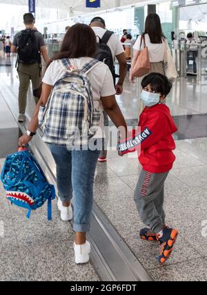 Hong Kong, China. 28th Sep, 2021. The Family that hid Edward Snowden is being given a new home in Canada. SUPUN THILINA KELLAPATHA, NADEEKA DILRUKSHI NONIS and children SETHUMDI and DINATH leave Hong Kong. The Snowden refugees are expected to land in Toronto this afternoon. In 2013 Edward Snowden revealed the scope of illegal surveillance being undertaken by his former employer, the NSA. Following these revelations, he found himself stranded in Hong Kong. (Credit Image: © Jayne Russell/ZUMA Press Wire) Stock Photo