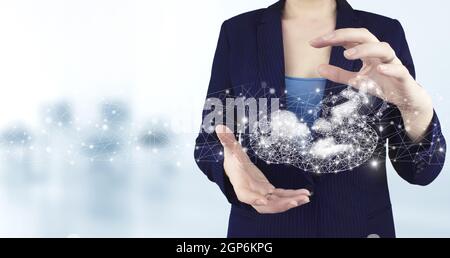 Two hand holding virtual holographic polygonal fetus icon with light blurred background. Neural networks and other concepts of modern technologies Stock Photo