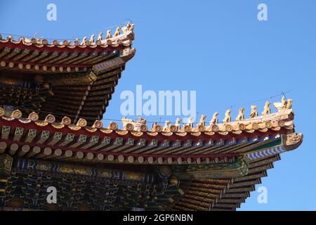 Tiled roof and facade decorated with a Chinese pattern. Palace in The Forbidden City, Beijing, China Stock Photo