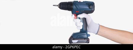 Master in glove holds a drill with drill on white background Stock Photo