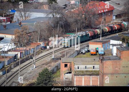 Krasnodar, Russia - February 23, 2017: Freight train traveling through the city buildings Stock Photo