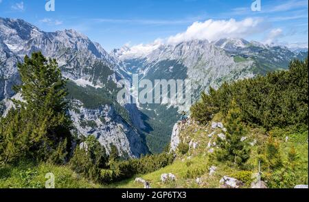 Hiker looking into the distance, view into the Reintal valley, in the background summit of the Zugspitze and Alpspitze with Zugspitzplatt, hiking Stock Photo