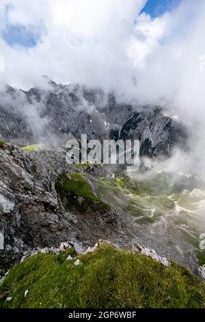 Cloud-covered rocky mountain peaks Oberreintalschrofen and Grosser Hundtsallkopfe, Frauenalpl, Wetterstein Mountains, Bavaria, Germany Stock Photo