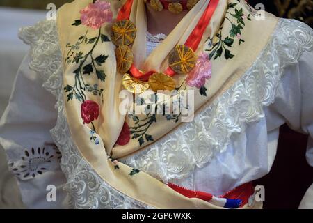 Girl dressed in traditional regional folk costumes in the church at the Mass on Thanksgiving day in Stitar, Croatia Stock Photo
