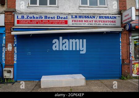 Slough, UK. 28th September, 2021. An abandoned matress outside a shop in Slough with the shutters down. Many businesses have failed to reopen since the Covid-19 Pandemic started. Credit: Maureen McLean/Alamy Stock Photo