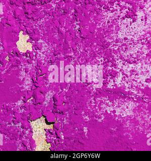 Old bright pink grunge material. Peeling paint and rust stains. Stock Photo