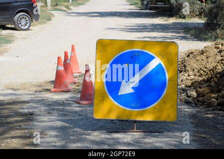 Sign of detour travel. Pit on the road. repair work Stock Photo