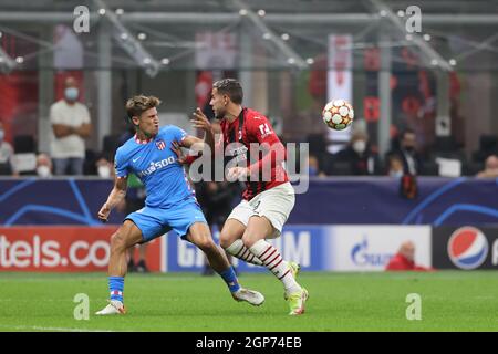 Milan, Italy. 28th Sep, 2021. Marcos Llorente of Club Atletico de Madrid fights for the ball against Theo Hernandez of AC Milan during the UEFA Champions League 2021/22 Group Stage - Group B football match between AC Milan and Club Atletico de Madrid at Giuseppe Meazza Stadium, Milan, Italy on September 28, 2021 Credit: Independent Photo Agency/Alamy Live News Stock Photo