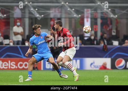 Marcos Llorente of Club Atletico de Madrid fights for the ball against Theo Hernandez of AC Milan during the UEFA Champions League 2021/22 Group Stage - Group B football match between AC Milan and Club Atletico de Madrid at Giuseppe Meazza Stadium, Milan, Italy on September 28, 2021 Stock Photo