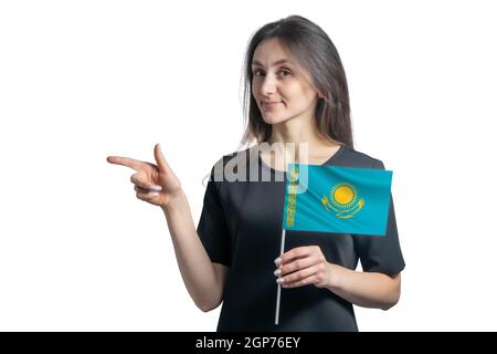 Happy young white woman holding flag Kazakhstan and points to the left isolated on a white background. Stock Photo