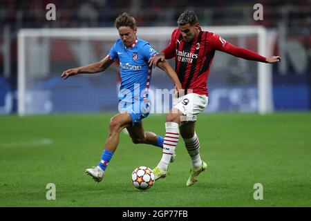 Marcos Llorente of Atletico Madrid  and Theo Hernandez of Ac Milan battle for the ball during the Uefa Champions League Group B  match between Ac Milan and Atletico Madrid at Stadio Giuseppe Meazza on September 28, 2021 in Milan, Italy . Stock Photo