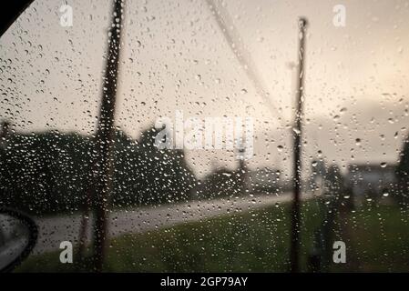 Detail of rain drops falling on the car window Stock Photo