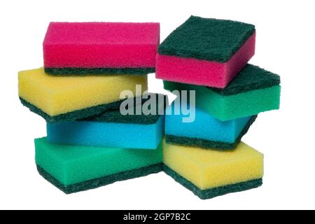 Closeup of a stack or heap of various colorful sponges or scouring pads isolated on a white background. Household chore concept. Top view. Macro. Stock Photo