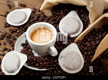 Coffee cups with pods on rustic table Stock Photo