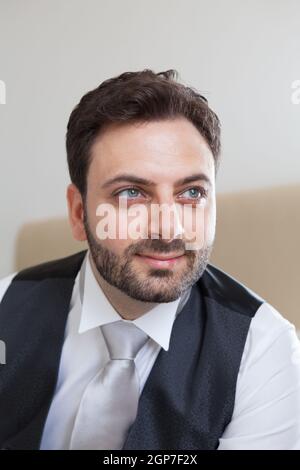 Young Italian groom with beard, brown hair and green eyes before marriage Stock Photo