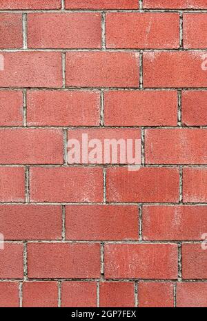 Modern red brick wall background with cracks in concrete Stock Photo