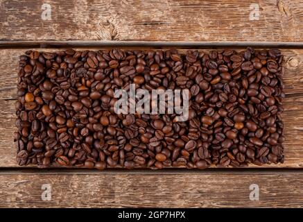 Rectangular shaped of coffee beans on wooden table Stock Photo