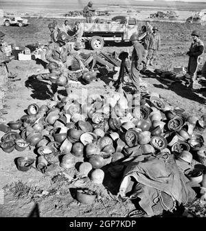 Pile of German helmets left by the Tenth and Fifteenth Panzer Divisions when their evacuation attempts from Porto Farina were frustrated, May 1943 Stock Photo