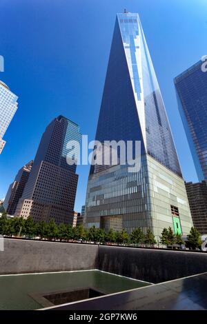 NEW YORK, NY - JULY 11, 2015: Freedom Tower and Memorial Fountain commemorating the September 11 attacks of 2001, located in lower Manhattan, stands 1