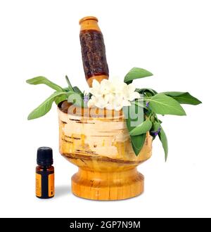 Healing herbs and edible flowers with mortar and pestle Stock Photo