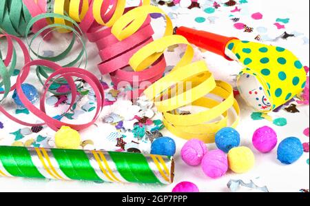 Colorful decoration with garlands, streamer, and confetti. Festive accessory background. Stock Photo