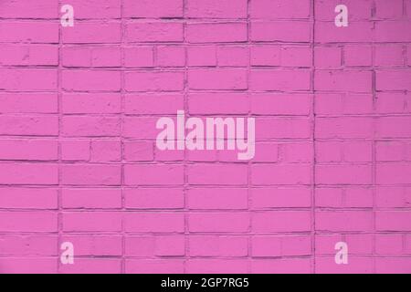 matte pink painted brick wall full frame flat background and texture Stock Photo