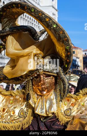 Golden mask with decorations and carvings during the Carnival of Venice 2015 edition. Stock Photo