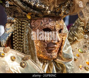 Golden mask with decorations and carvings during the Carnival of Venice 2015 edition. Stock Photo