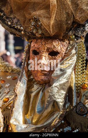 Golden mask with decorations and carvings during the Carnival of Venice 2015 edition. Stock Photo