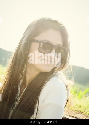 Portrait of a teenager with sunglasses photographed in backlight Stock Photo