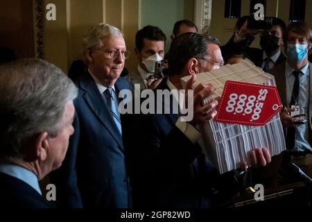 United States Senate Minority Leader Mitch McConnell (Republican of Kentucky), left, listens as United States Senator John Barrasso (Republican of Wyoming) holds up a copy of the $3.5 trillion infrastructure bill as he offers remarks at a press conference following the Senate Republicanâs policy luncheon at the US Capitol in Washington, DC, Tuesday, September 28, 2021. Credit: Rod Lamkey/CNP Stock Photo
