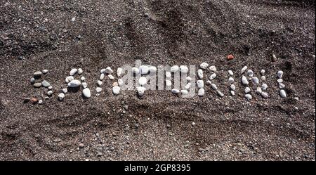 Text Santorini made with pumice stones on the volcanic beach at Kamari Stock Photo