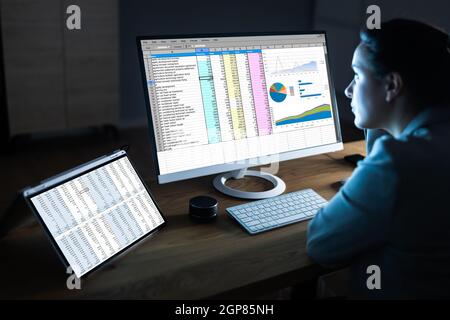 Woman Using Finance Spreadsheet Report On Laptop Screen Stock Photo