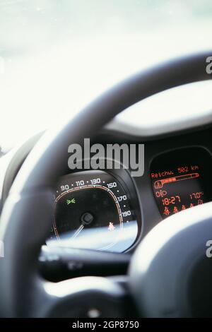 Close up of a steering wheel with remote control, blurry dashboard Stock Photo