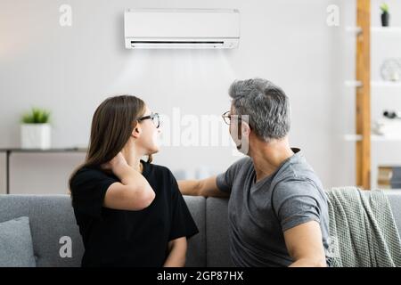 Air Conditioner Couple Sneezing And Having Sore Neck Stock Photo