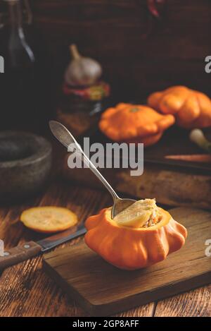 Preparing yellow pattypan squash for stuffing with minced meat Stock Photo