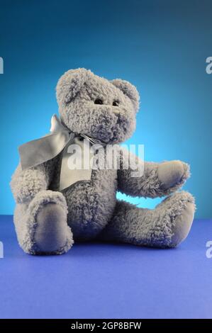 A fluffy blue teddy bear over a complimenting background. Stock Photo