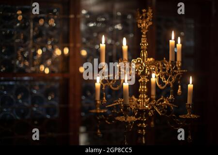 Splendid chandelier with lit candles in a beautiful room of an old mansion Stock Photo