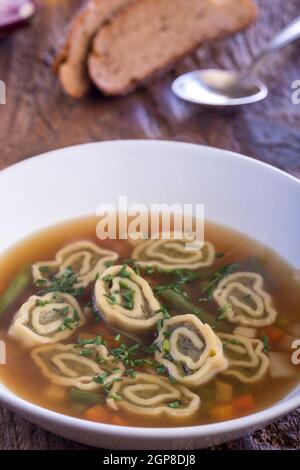 bavarian maultasche soup on wood Stock Photo