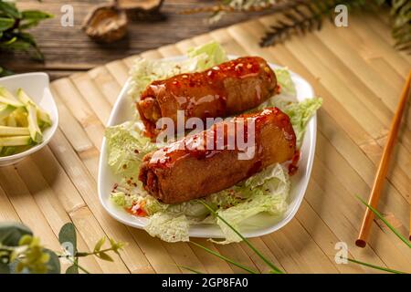Fresh fried Chinese spring rolls food with green salad Stock Photo